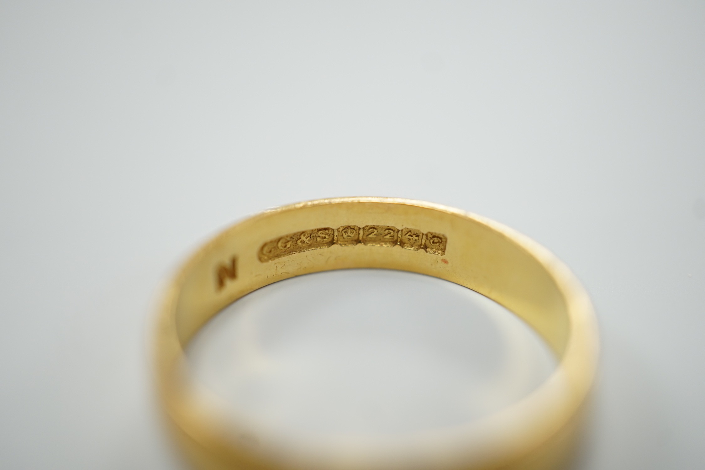 A thin Victorian 22ct gold wedding band, London, 1875, size K/L and two later 22ct gold wedding bands, including Edwardian (1901), size I, and Elizabeth II (1969), size N, 11.1 grams.